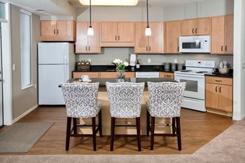 A kitchen with white appliances and wooden cabinets